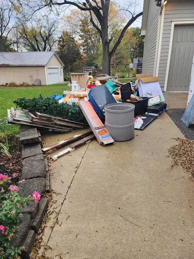 Dumpster being loaded with debris for Estate Cleanout Dumpster Rental in Rockville